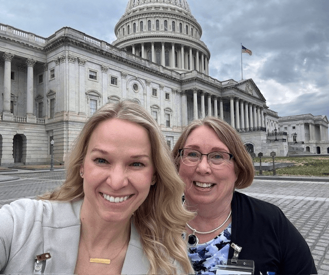 dawn hunt and lori zahradka smiling in front of the united states capitol building